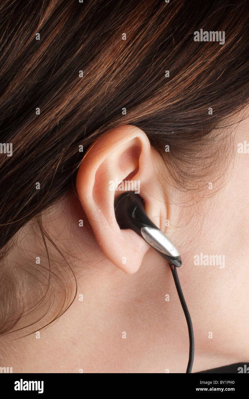 Girl listening to music through earphones Stock Photo Alamy