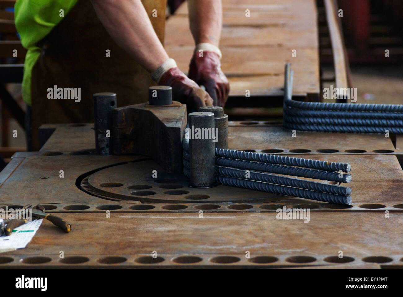 Concrete reinforcement steel rebar cut and bent factory. Worker