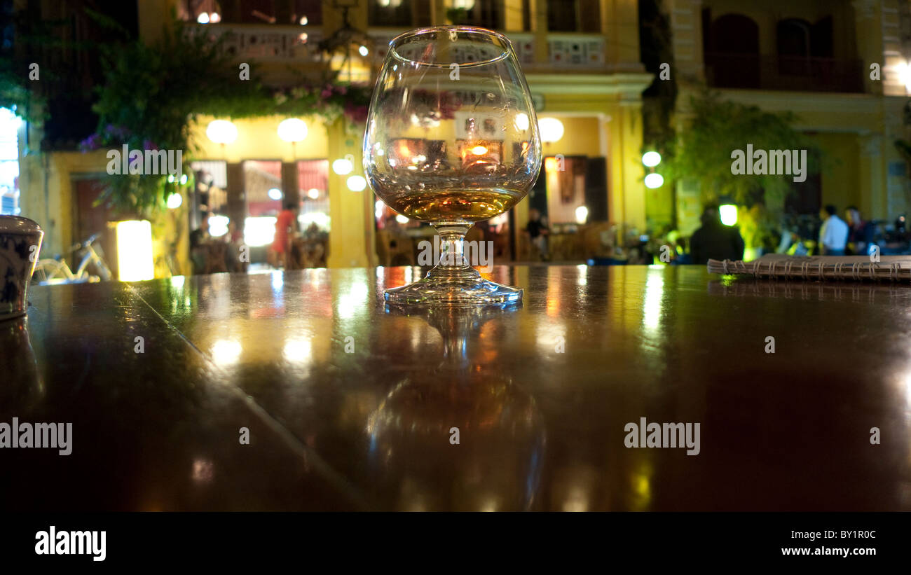 Glass on table at night, Hoi An, Vietnam Stock Photo