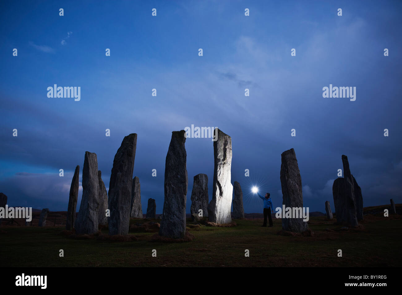 Callanish standing stones lit by light at night, Isle of Lewis, Western Isles, Scotland Stock Photo