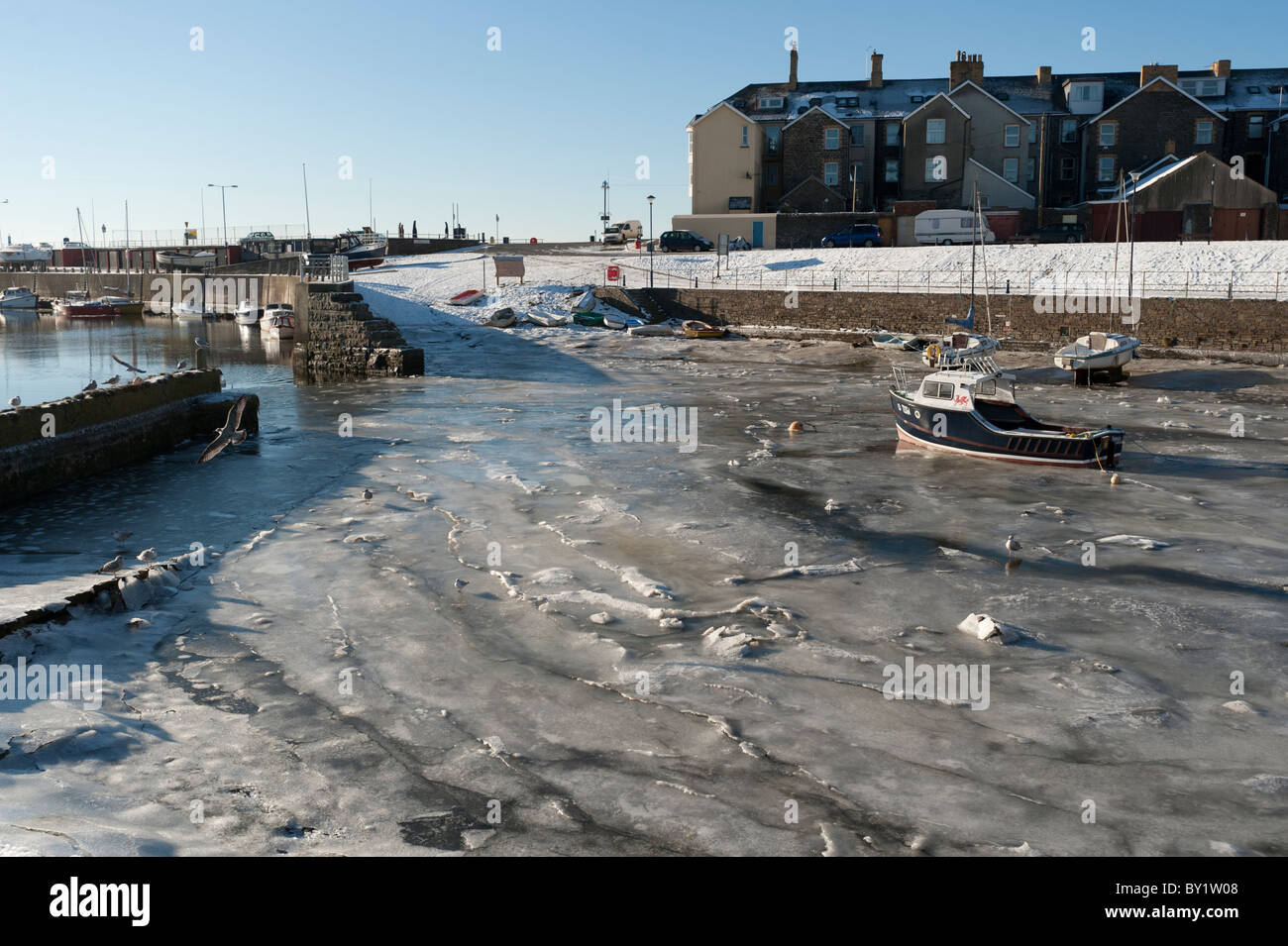 December 25 2010. Boats Aberystwyth harbour frozen into the thick ice after another night of sub-zero temperatures. Stock Photo