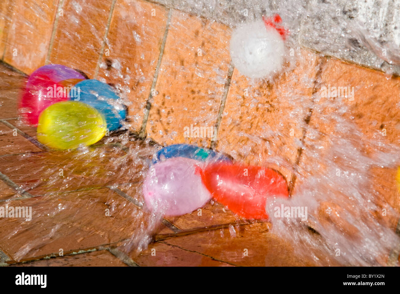 Water filled multicolored balloons explosion Stock Photo