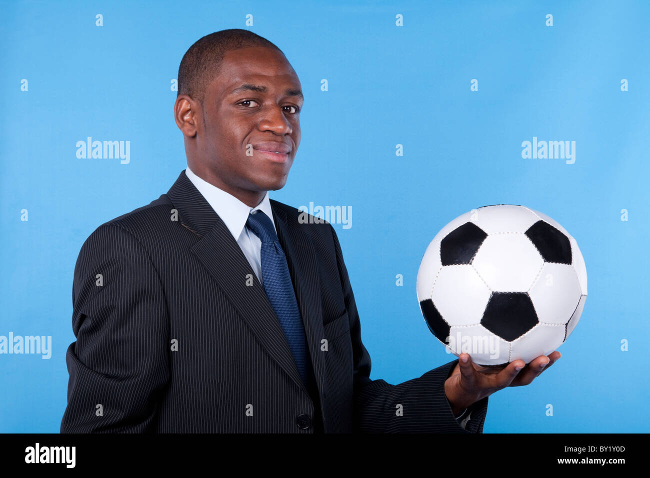 African businessman holding a soccer ball Stock Photo - Alamy