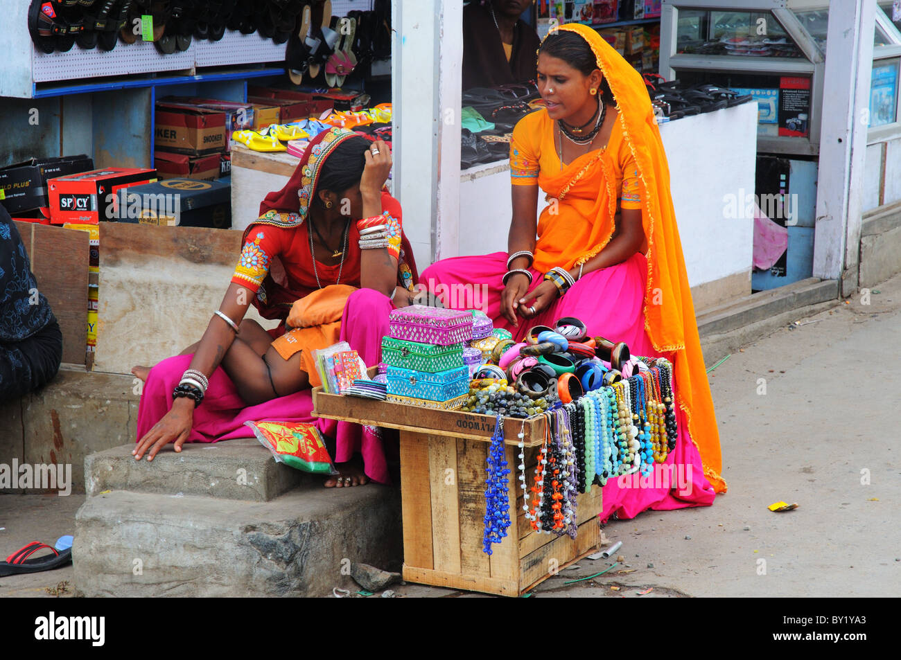 Two women and their jewellery stall in India Stock Photo