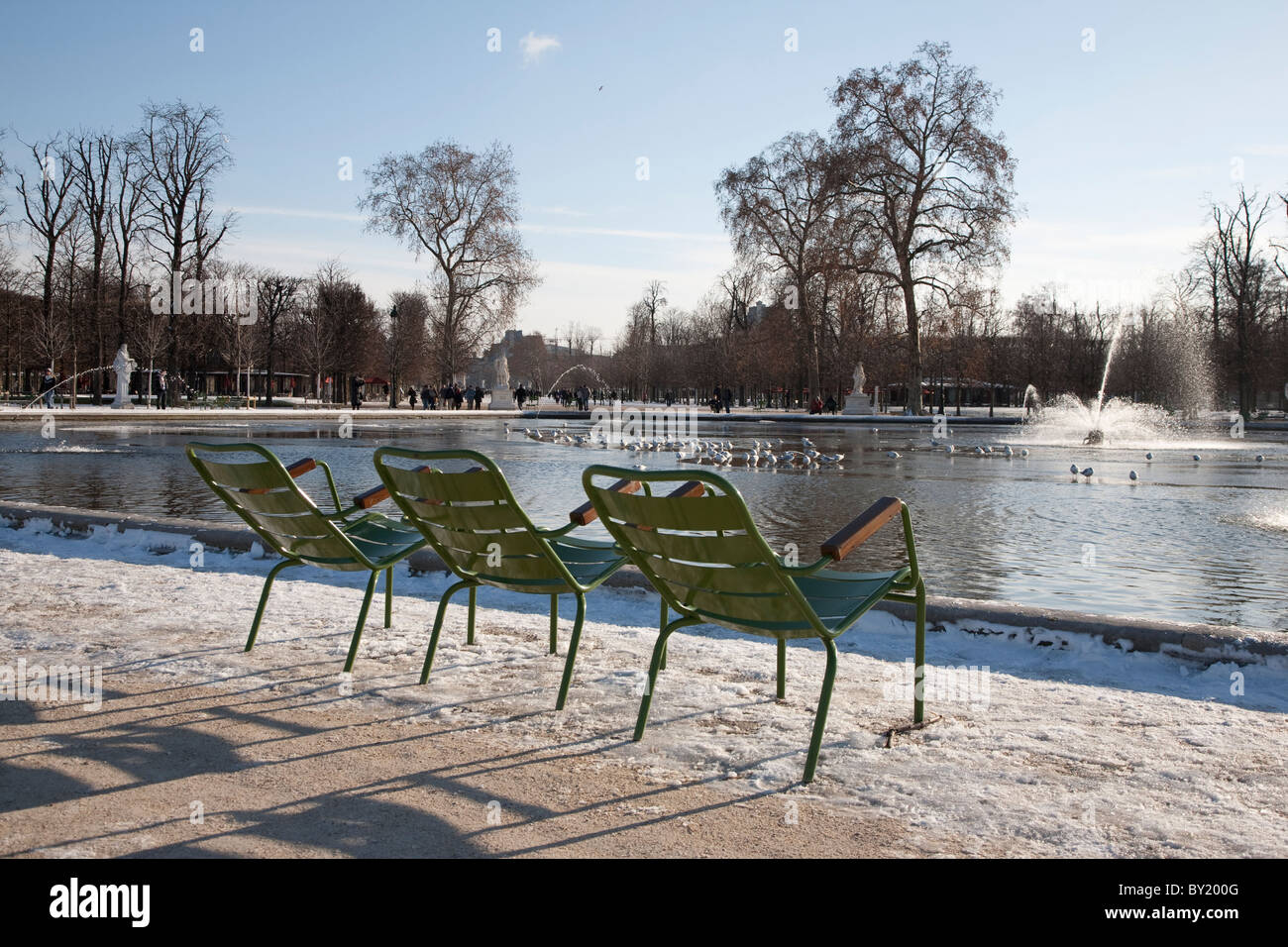 Three Chairs before a Lake in Tuileries Garden in Paris in Winter, France Stock Photo