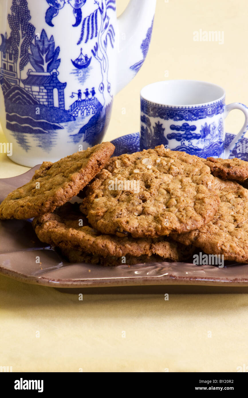 Close-up of oatmeal cookies and a tea pot and cup Stock Photo