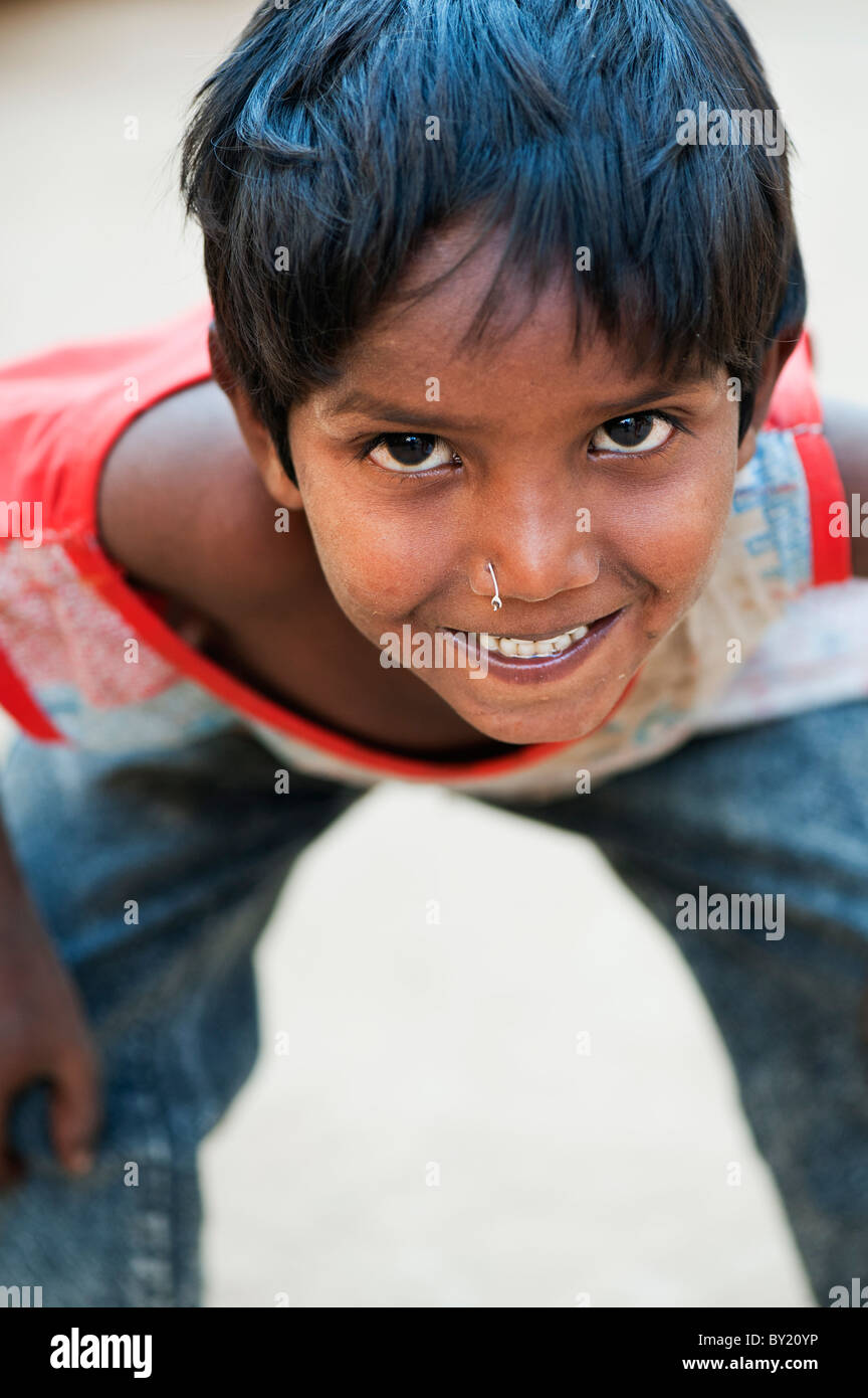 Happy young poor lower caste Indian street boy smiling. Andhra Pradesh, India. Selective focus. Stock Photo