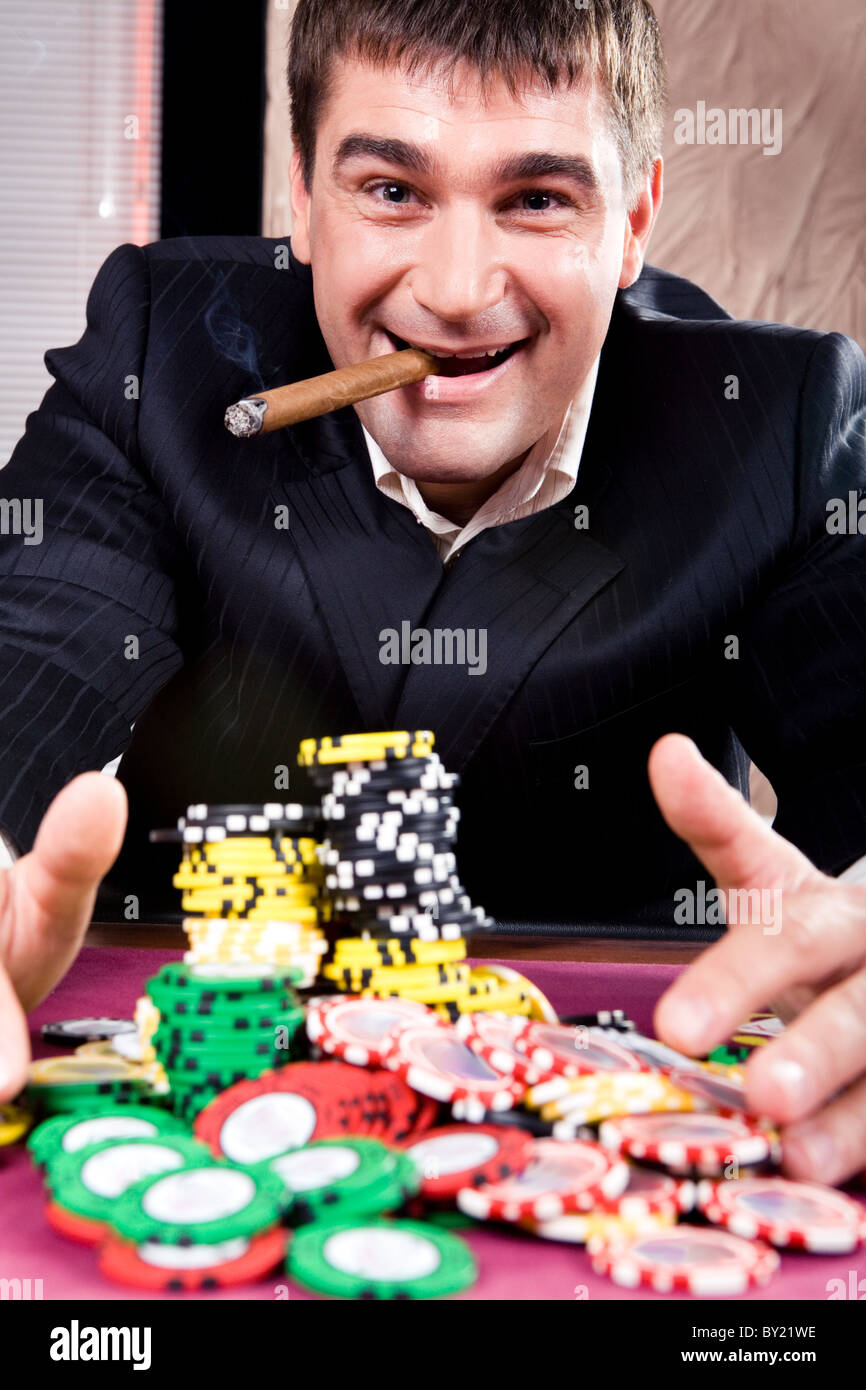 Portrait of a man collecting casino chips