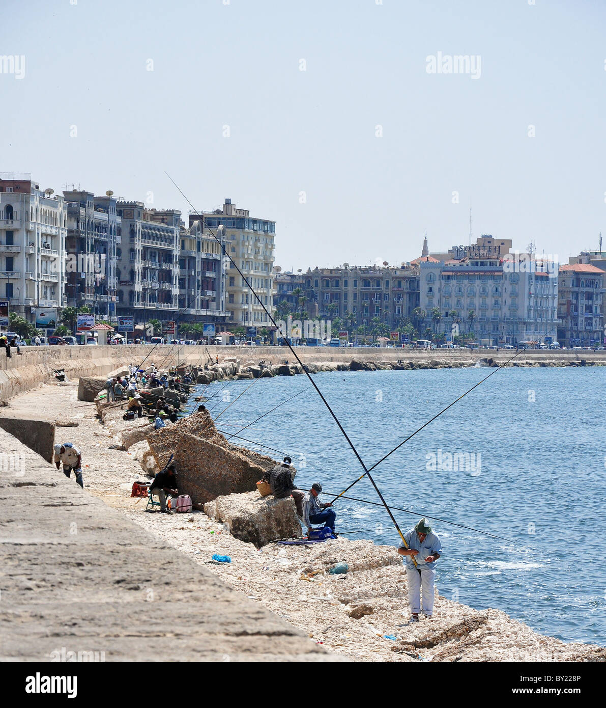 Fishermen fishing into the Alexandria Harbor in Alexandria, Egypt. Stock Photo