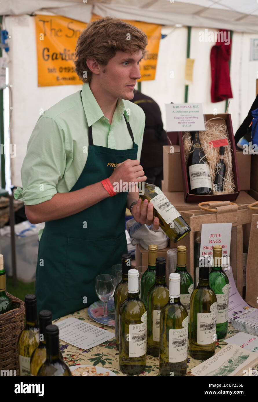 England, Shropshire, Ludlow.  A young man at the Ludlow Food Festival selling wine from the Frome Valley Vineyard. Stock Photo