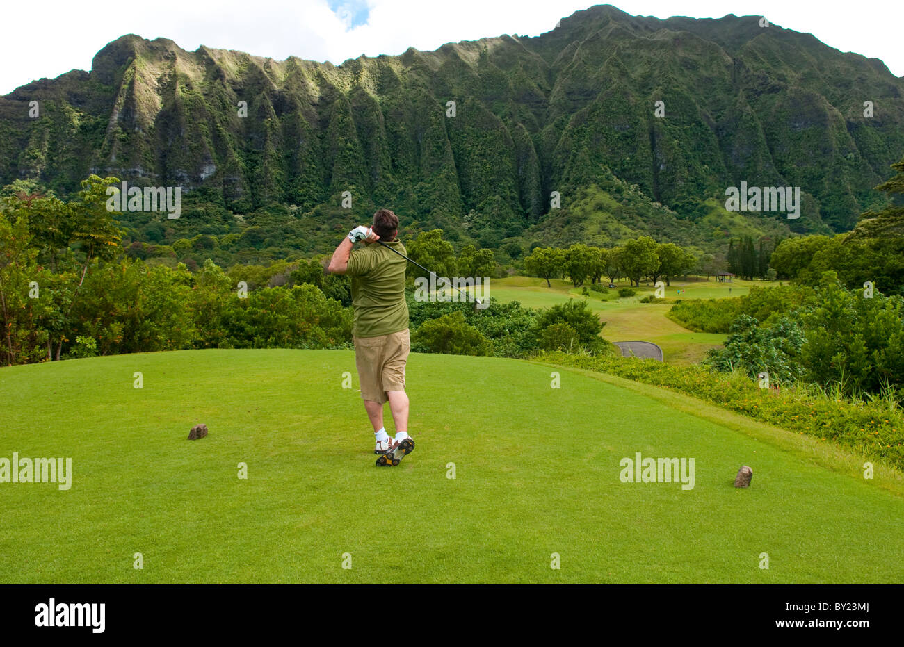 Golfer driving on beautiful 5th hole on Ko'olau Golf Course in Honolulu