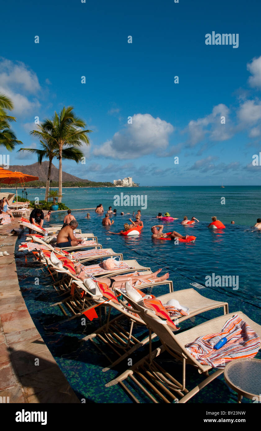 Tourists relaxing at edgeless pool at Sheraton Waikik Beach Hotel in Honolulu Hawaii Oahu Stock Photo