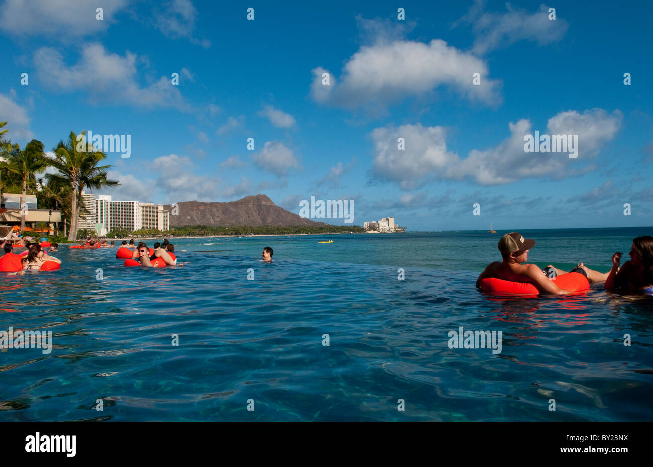 Tourists relaxing at edgeless pool at Sheraton Waikik Beach Hotel in Honolulu Hawaii Oahu Stock Photo