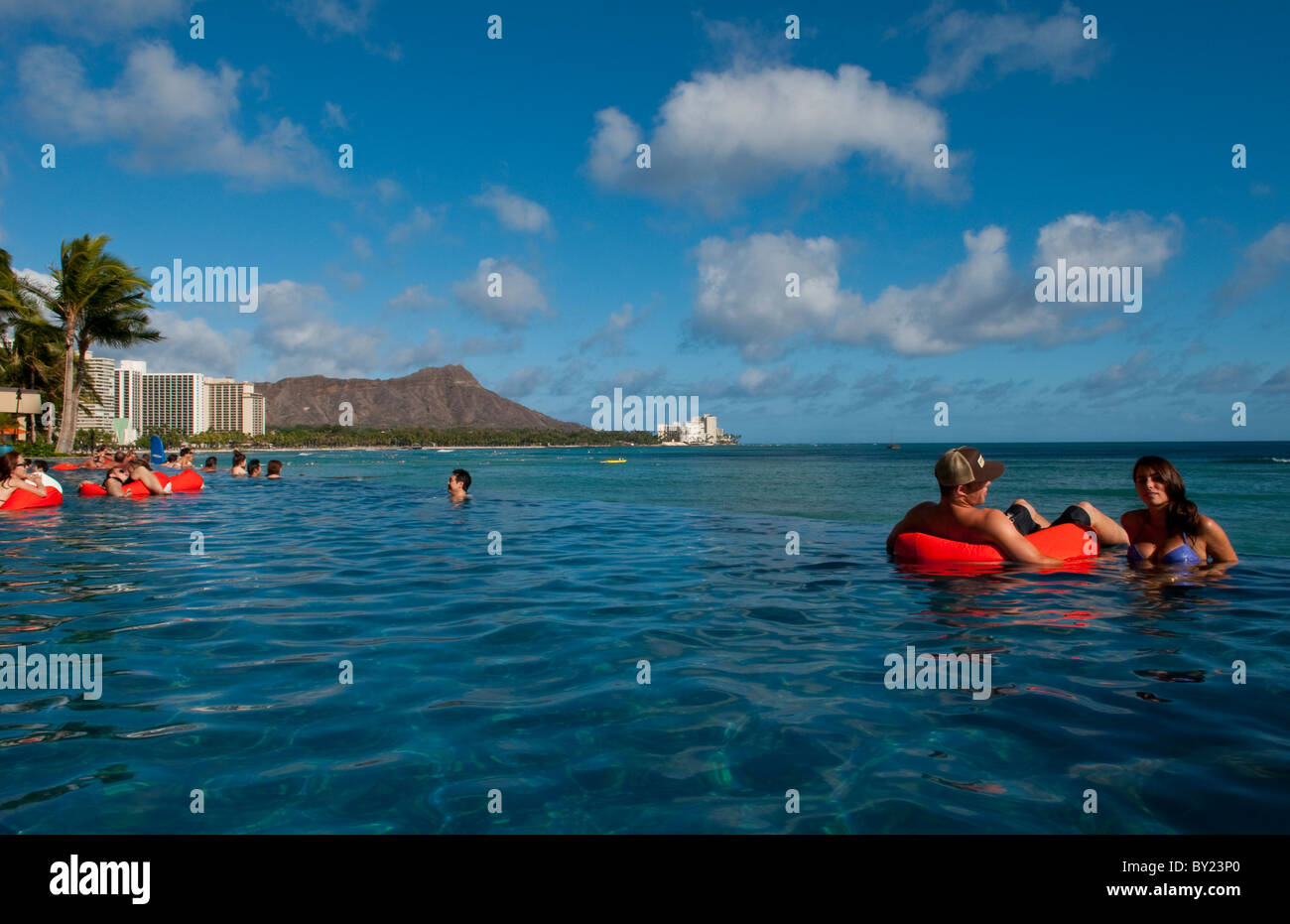 Tourists relaxing at edgeless pool at Sheraton Waikik Beach Hotel in Honolulu Hawaii Oahu Stock Photo