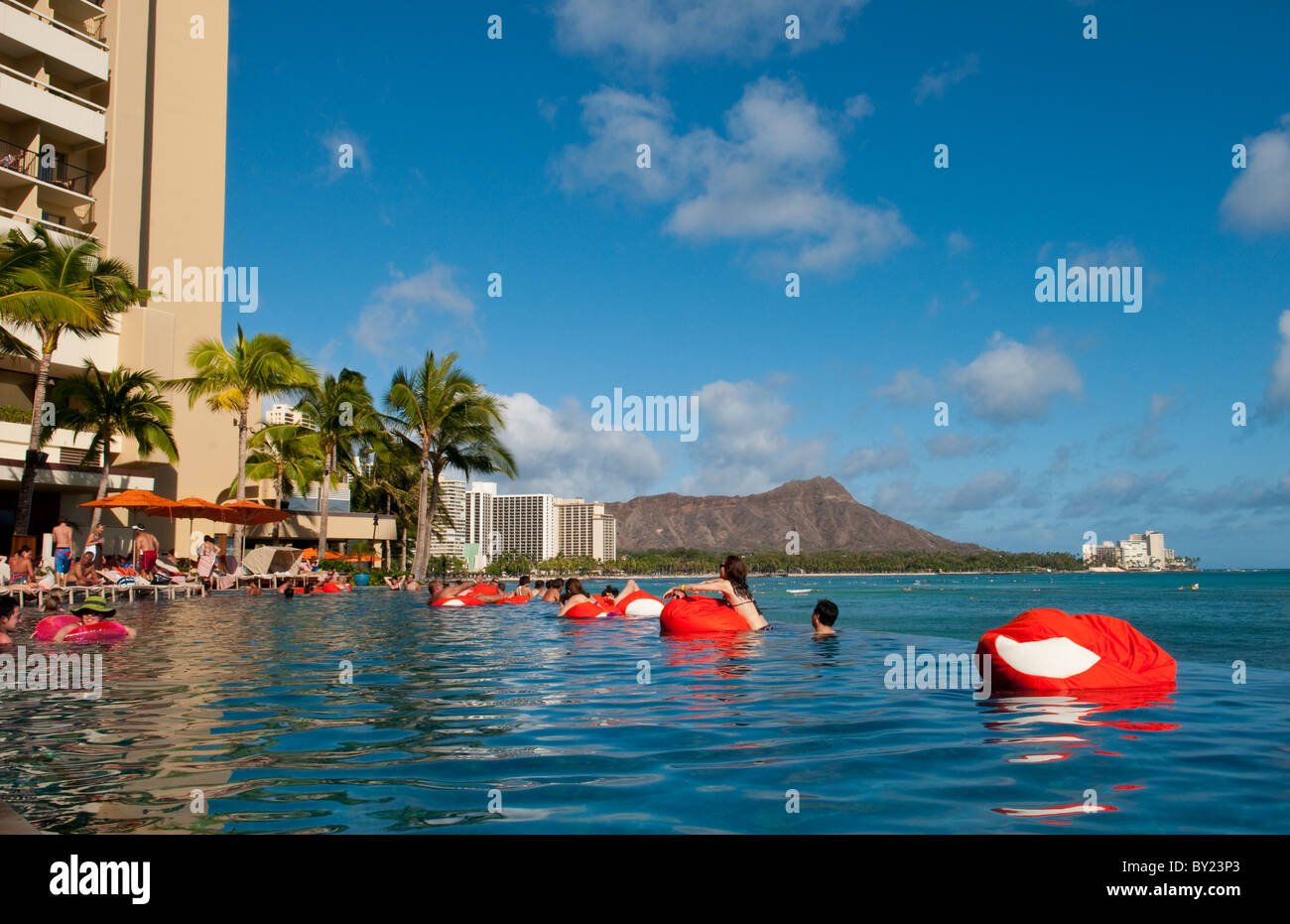 Tourists relaxing at edgeless pool at Sheraton Waikik Beach Hotel in Honolulu Hawaii Oahu Stock Photo