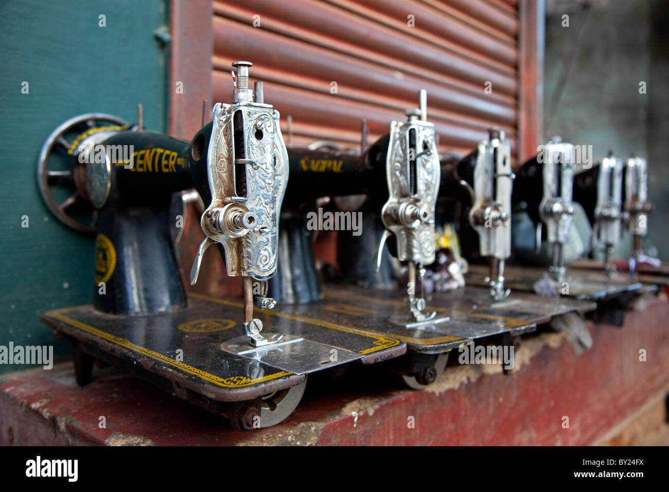 India, Mysore. Recentlyrepaired sewing machines lined up outside a