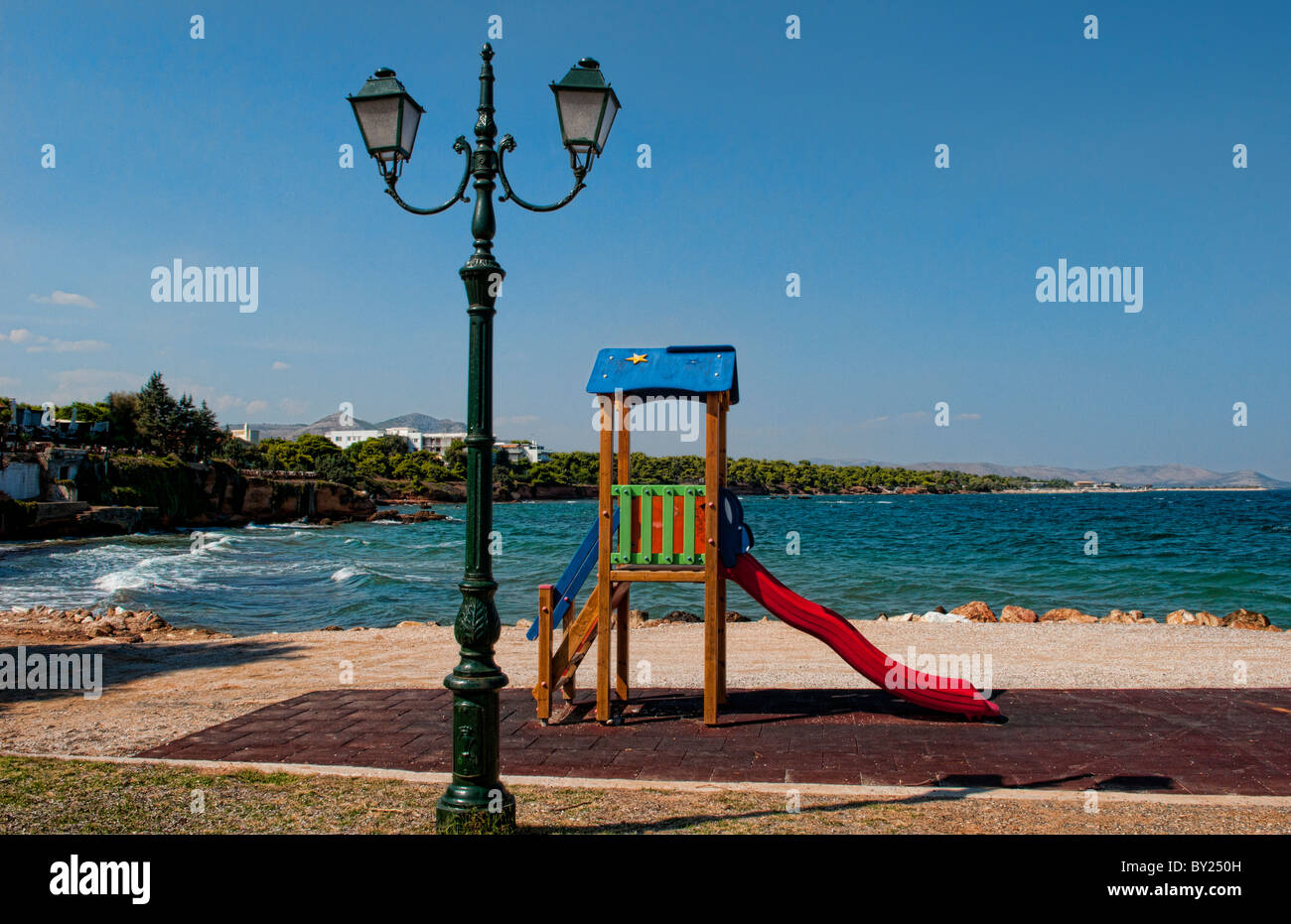 Mati Greece little park with colorful slide for children on beach resort  Stock Photo - Alamy