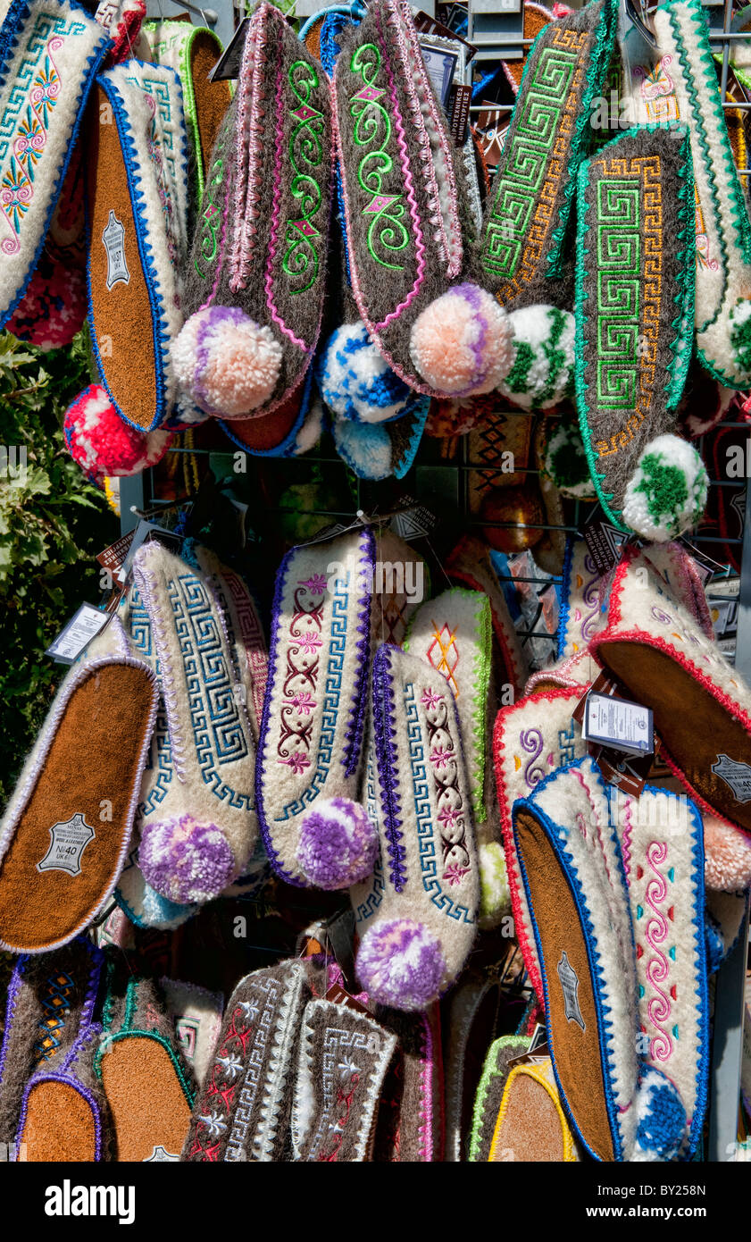Display of Greek souvenirs shoes on rack in downtown shopping area of