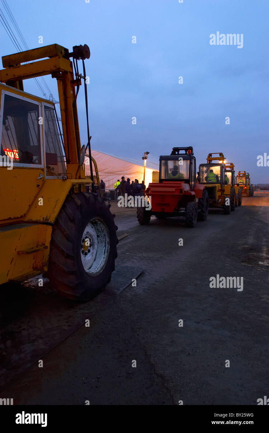 Forklifts at auction dusk Stock Photo Alamy