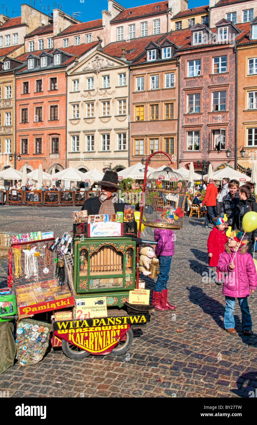 Older man who plays old fashioned music in middle of Main Old Town Main Square Warsaw Poland Stock Photo