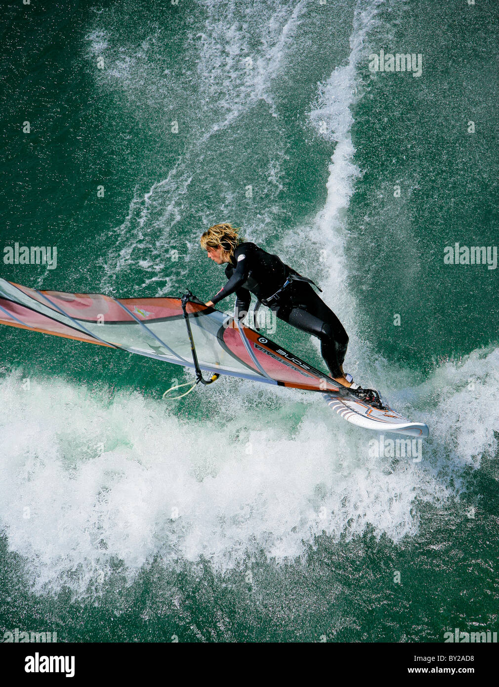 A windsurfer throws a move during a sweet summer session under the Maryhill Bridge. Stock Photo