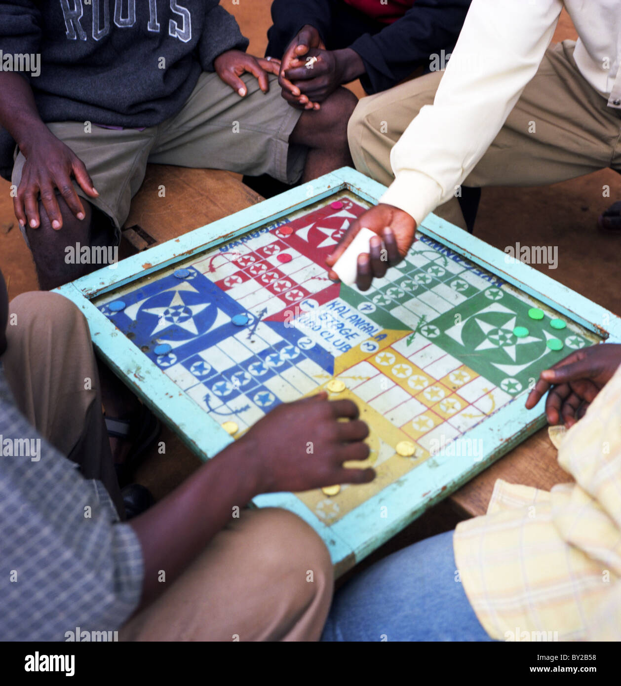 A group of men playing the game Ludo in Uganda. Africa Stock Photo