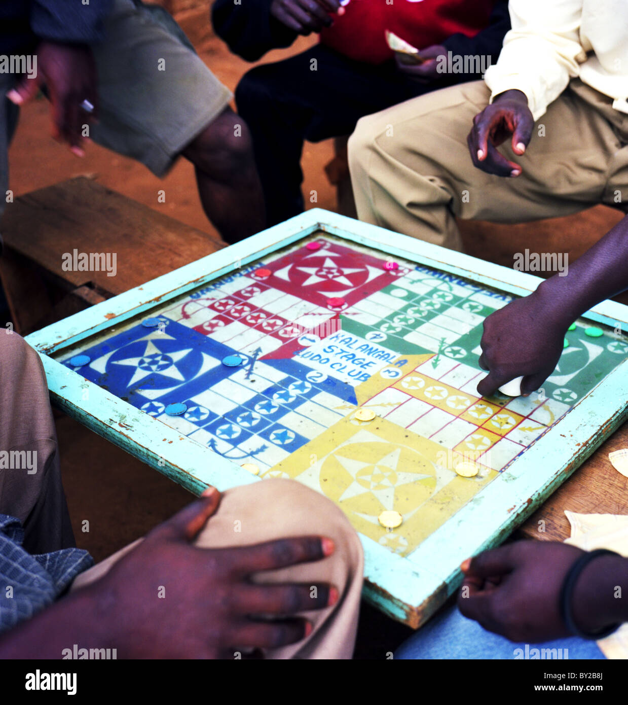 A group of men playing the game Ludo. Uganda. Africa Stock Photo