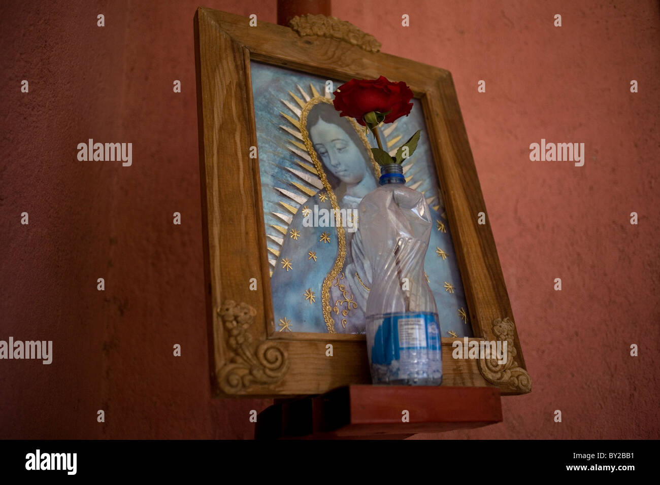 An Our Lady of Guadalupe picture is displayed in a shelter located along the railroad in Ixtepec, Oaxaca, Mexico. Stock Photo