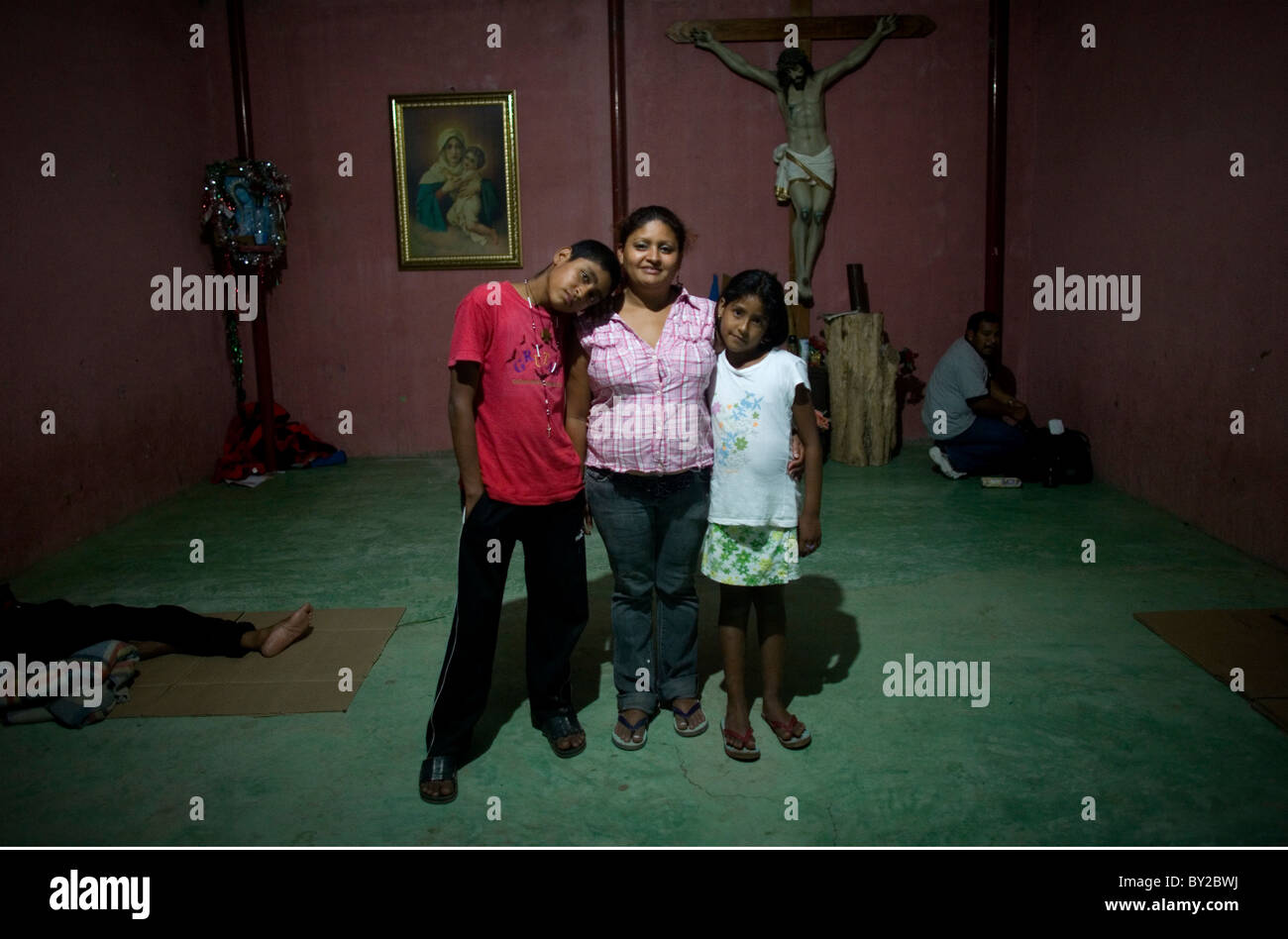 Central American migrants pose for a picture in a shelter located along the railroad in Ixtepec, Oaxaca, Mexico. Stock Photo