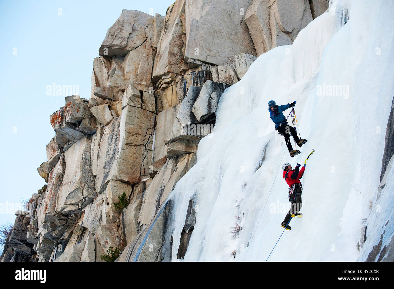 A photographer photographs an ice climber in Calif. Stock Photo