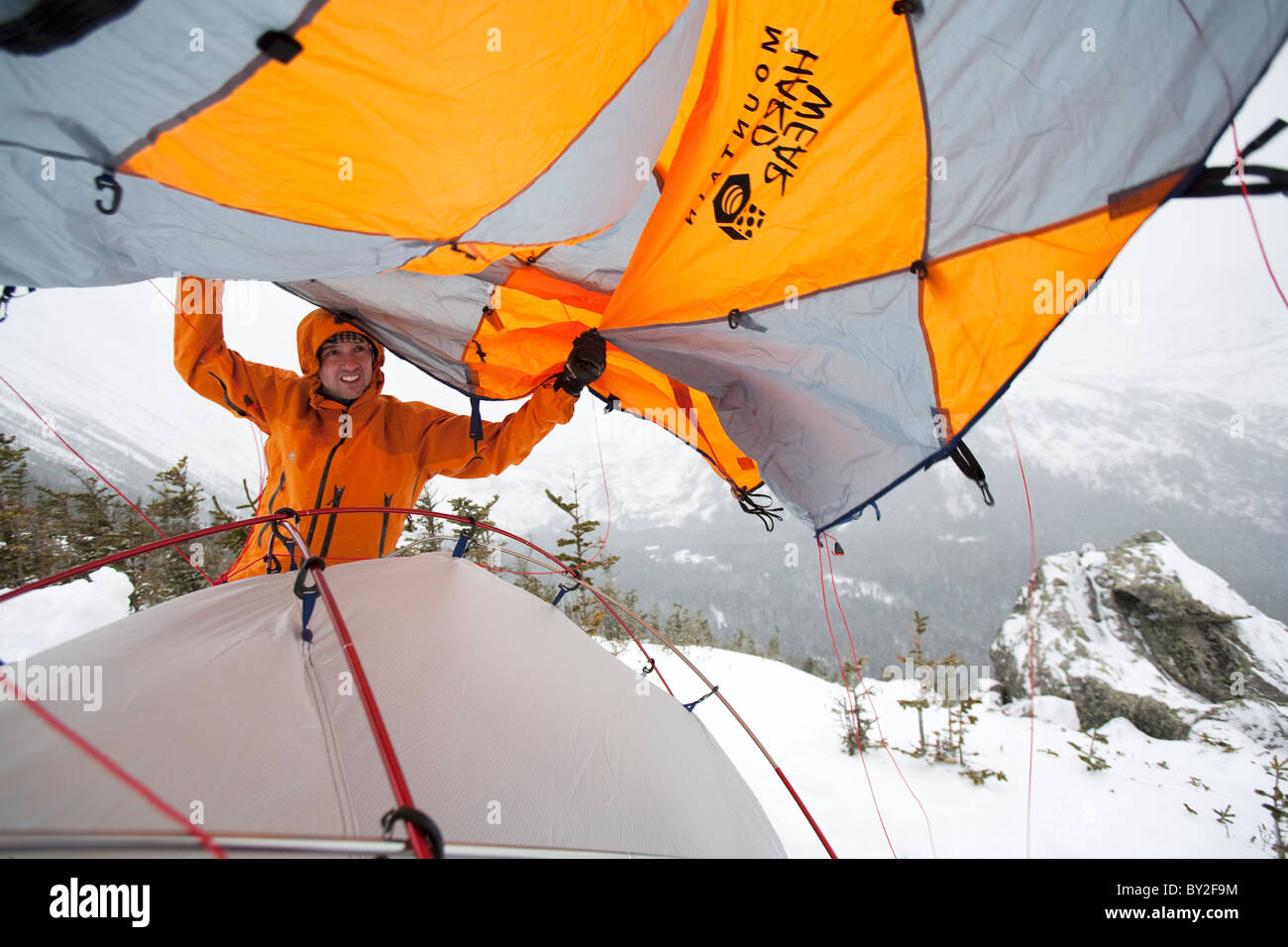 A man sets up camp in the deep snow on Mt. Washington. Stock Photo
