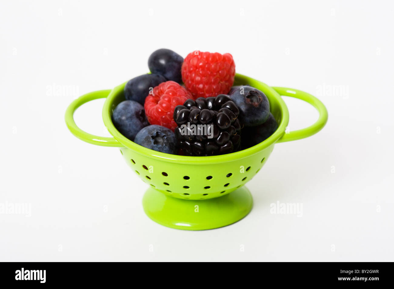 A small colander filled with fresh berries Stock Photo