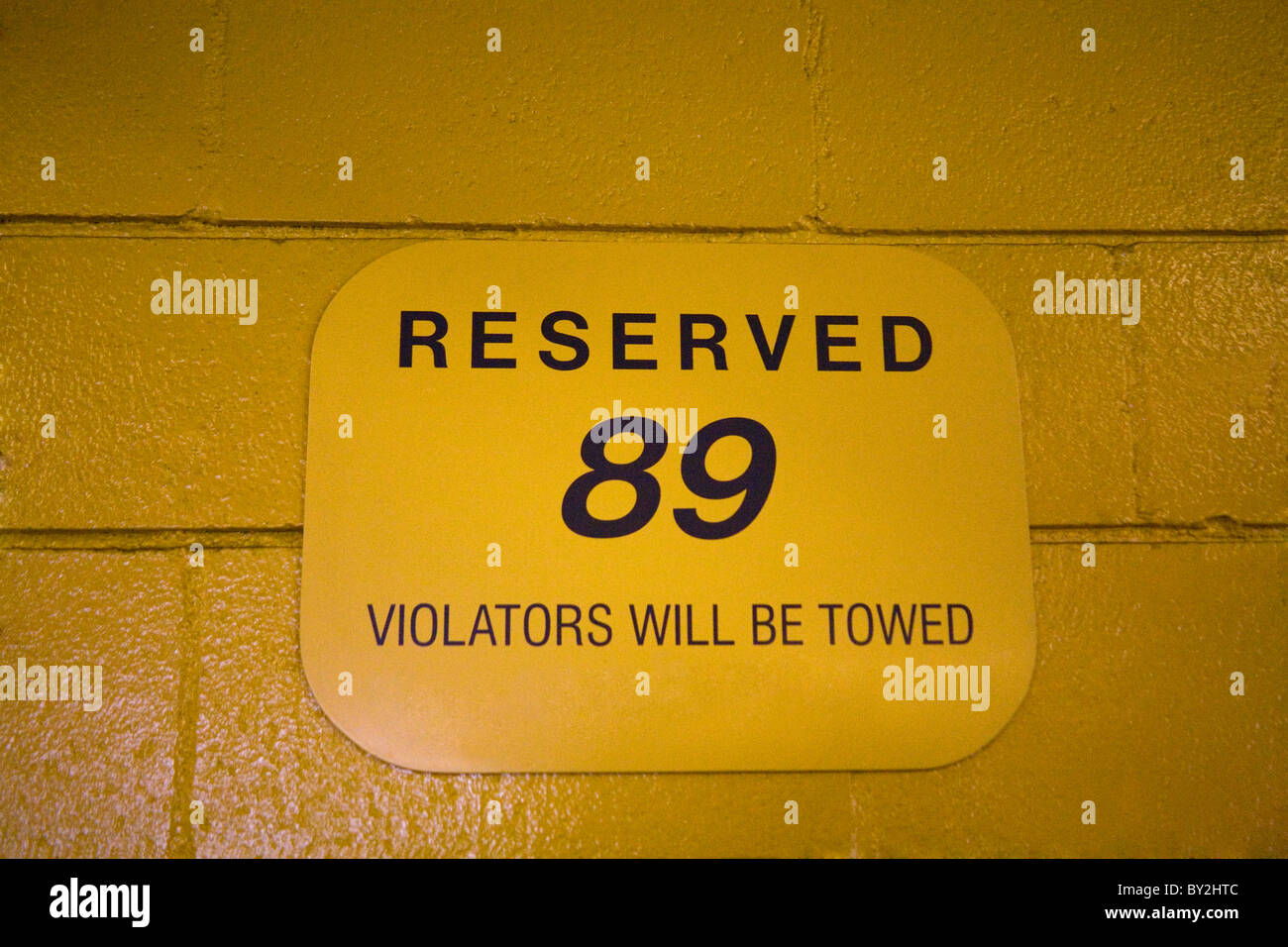 Reserved yellow parking space sign with numbers Stock Photo