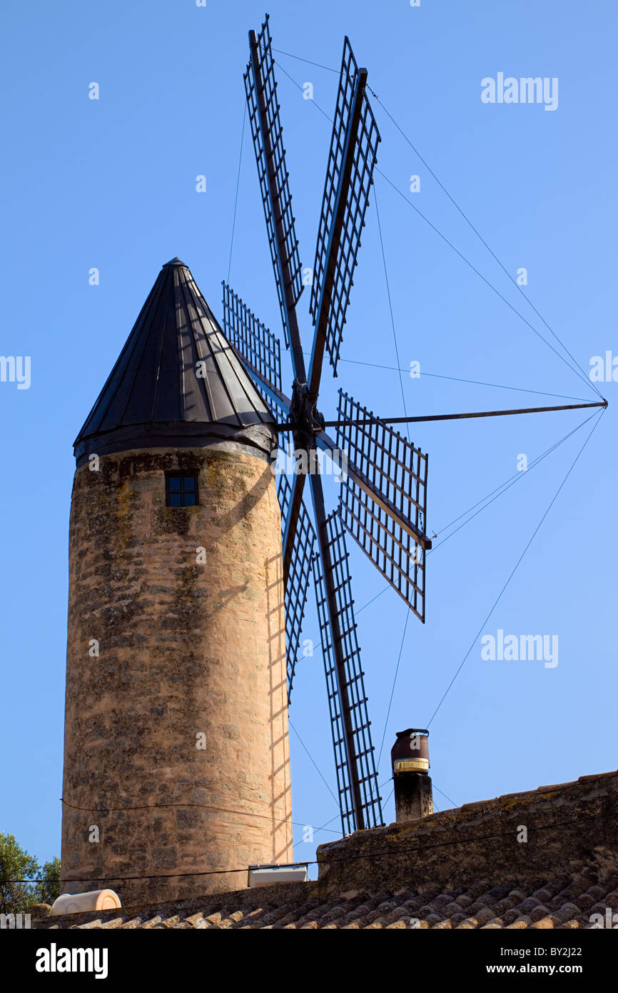 Ancient windmill in Majorca with a blue sky as background Stock Photo