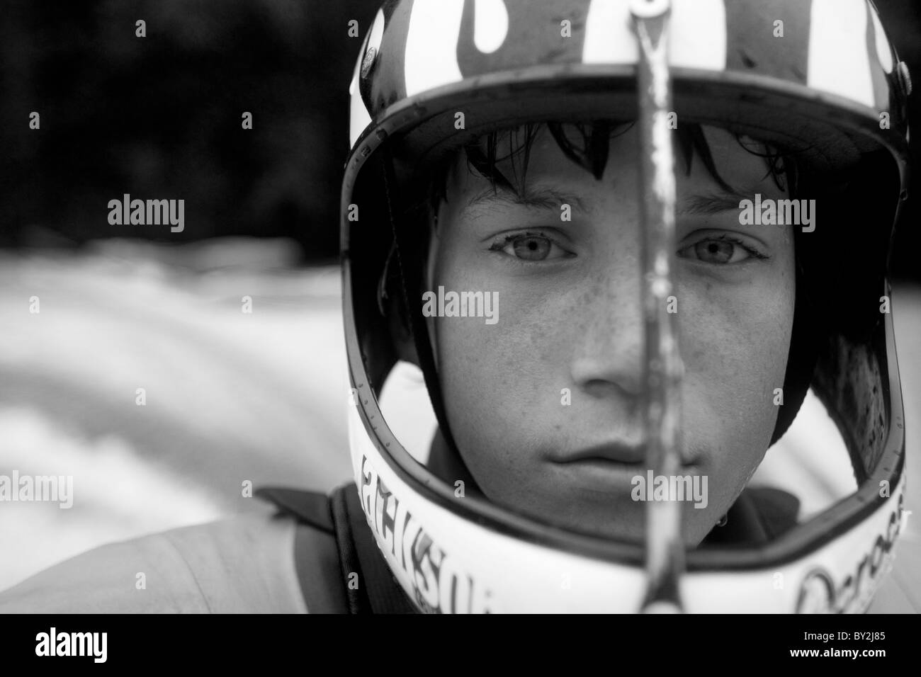 Black and white portrait of a young kayaker wearing a full face helmet. Stock Photo