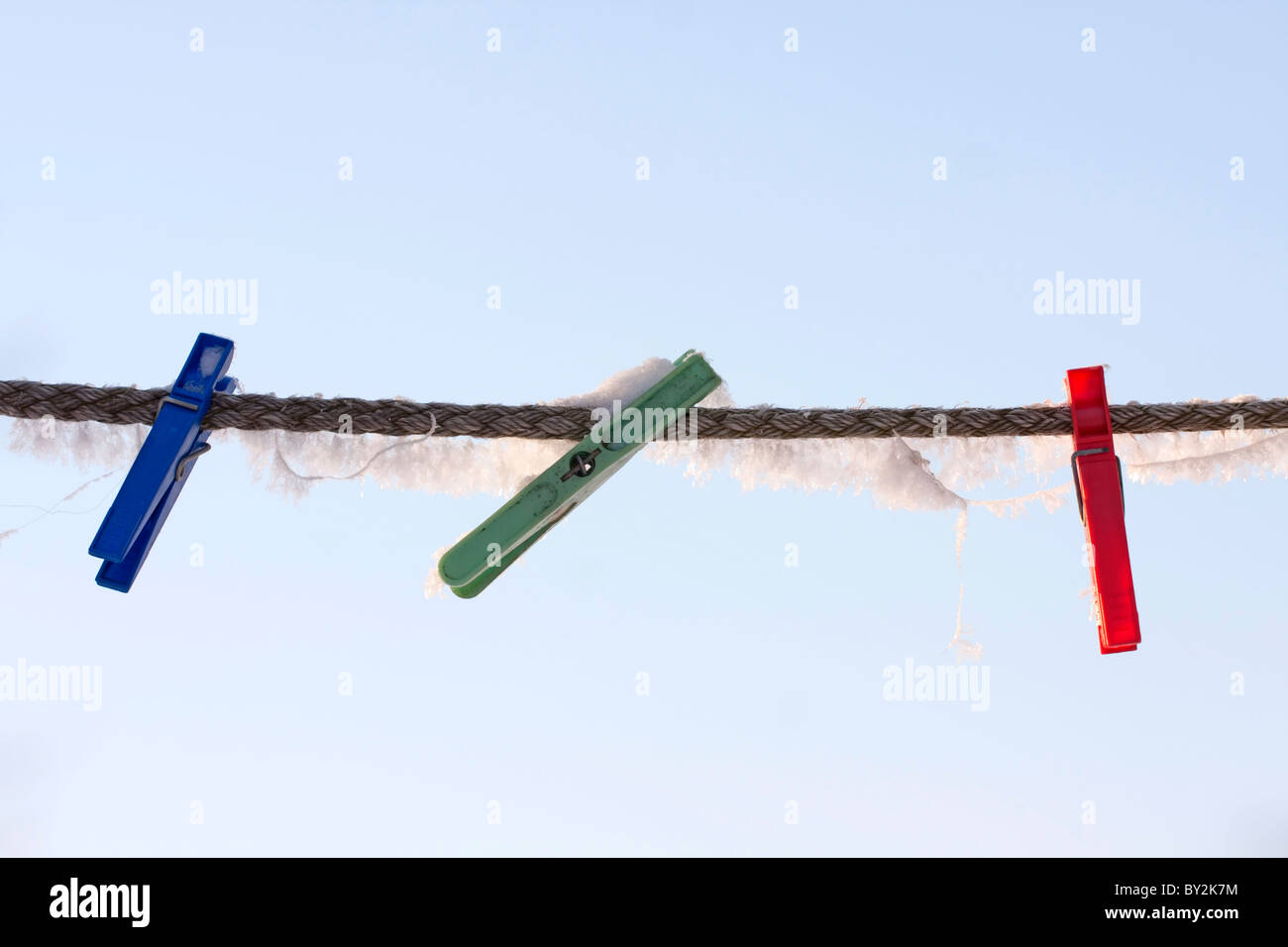 Frozen pegs on the wire. Stock Photo