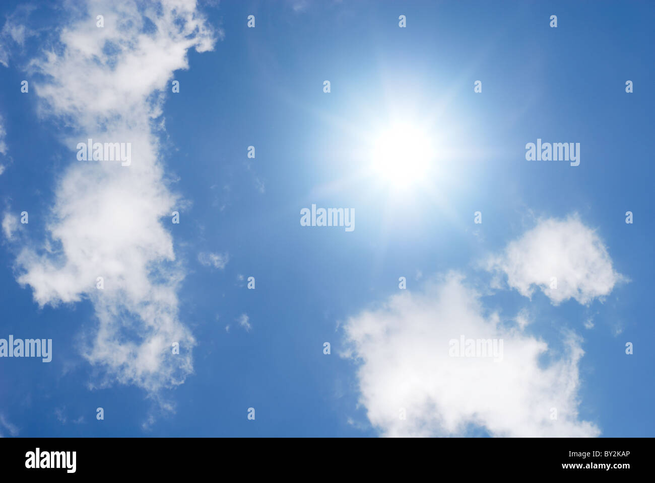 Sun in blue sky and white clouds Stock Photo