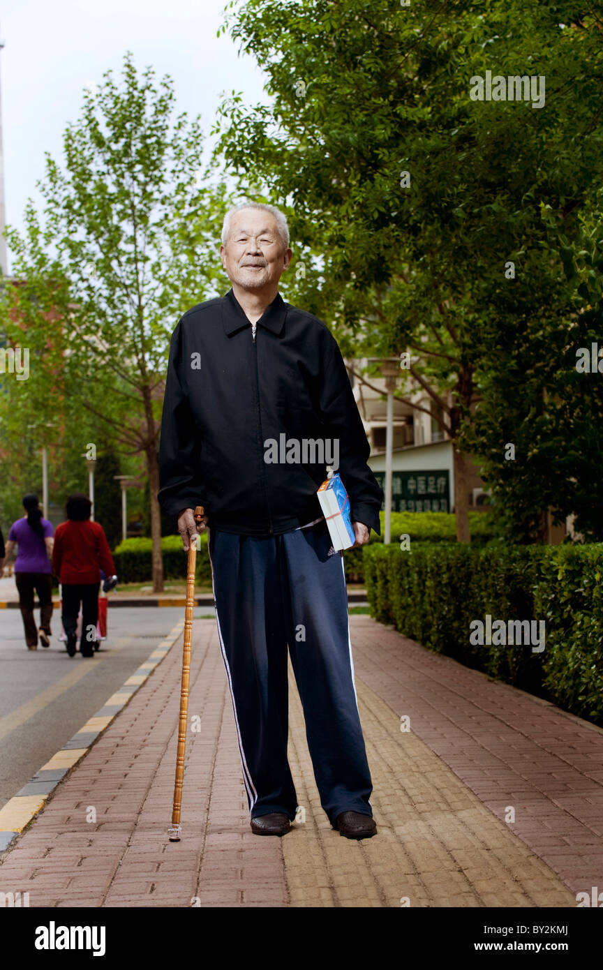 An old man with a walking cane Stock Photo - Alamy