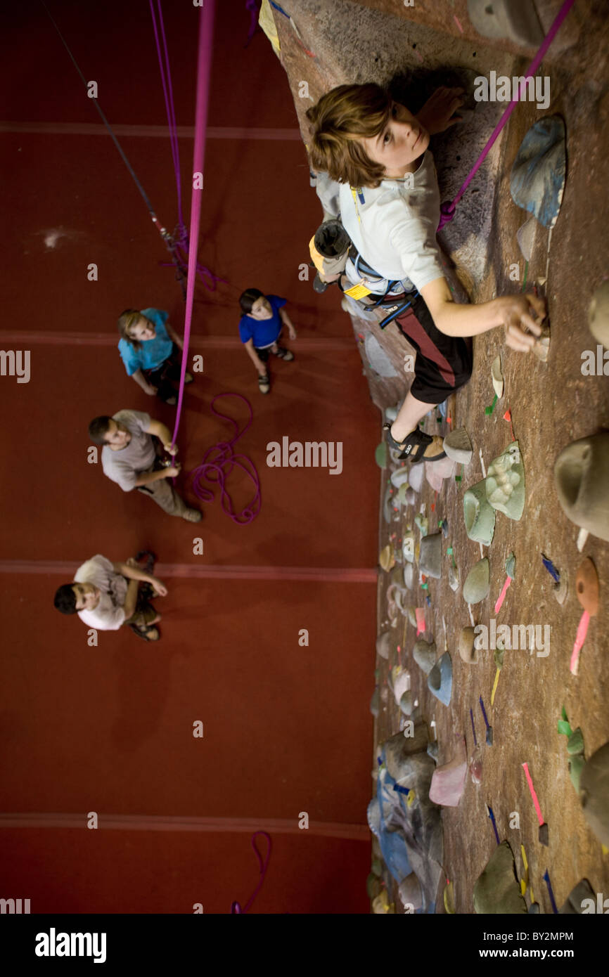 A young male teen rock climber top ropes at a rock climbing gym Stock Photo Alamy