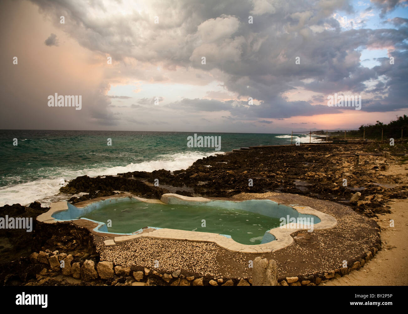 Oceanside Pool A dramatic sky over a small oceanside pool Stock Photo - Alamy