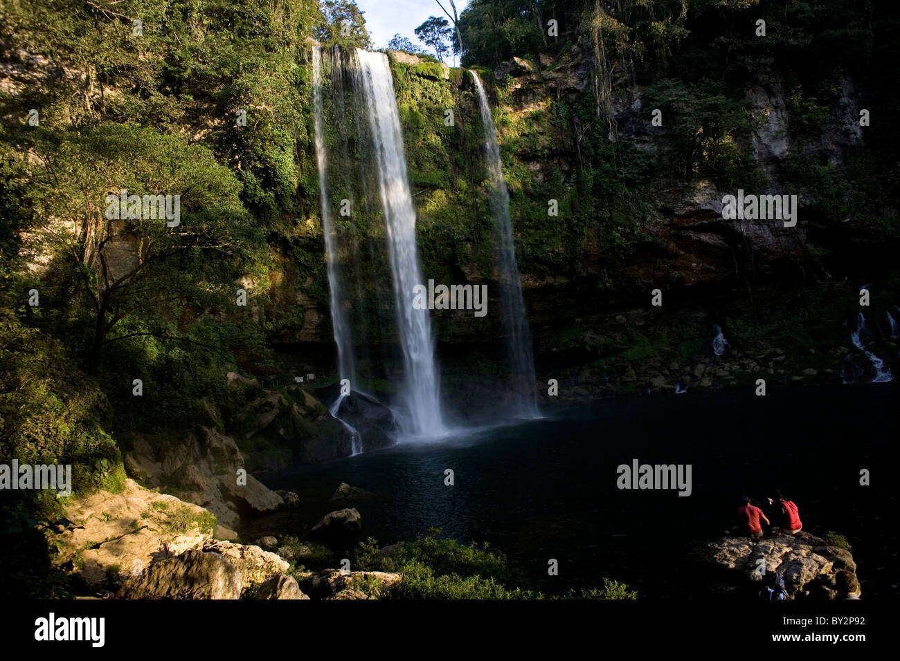 Tourists watch the sun set at the Misol Ha waterfall in Salto de Agua, Chiapas, Mexico Stock Photo