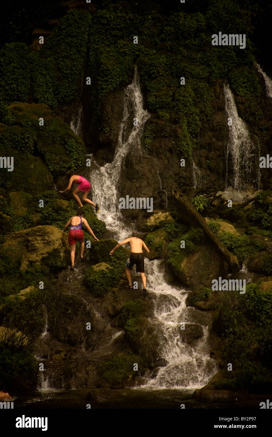 Tourists walk on the rocks at the Misol Ha waterfall in Salto de Agua, Chiapas, Mexico Stock Photo