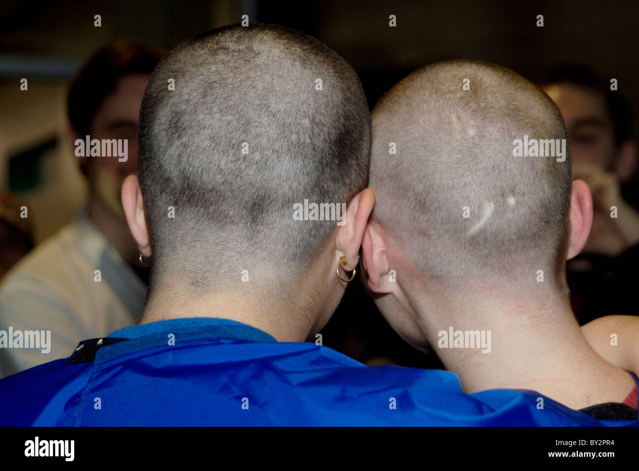 Back of two young women side by side with shaved heads for cancer Stock Photo