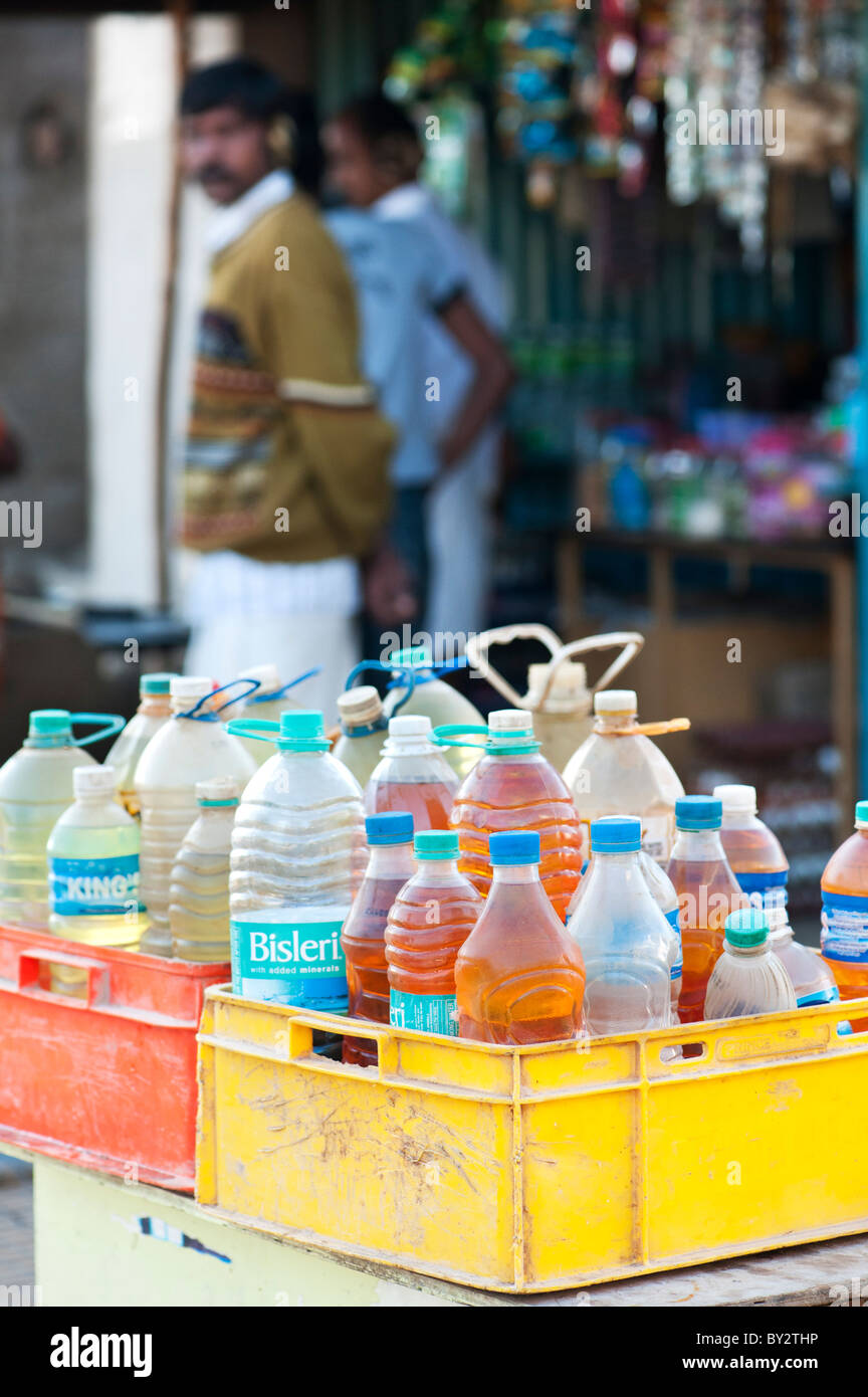 Indian petrol sold in plastic bottles outside a shop mainley used by the ricksaws. Puttaparthi, Andhra Pradesh, India Stock Photo