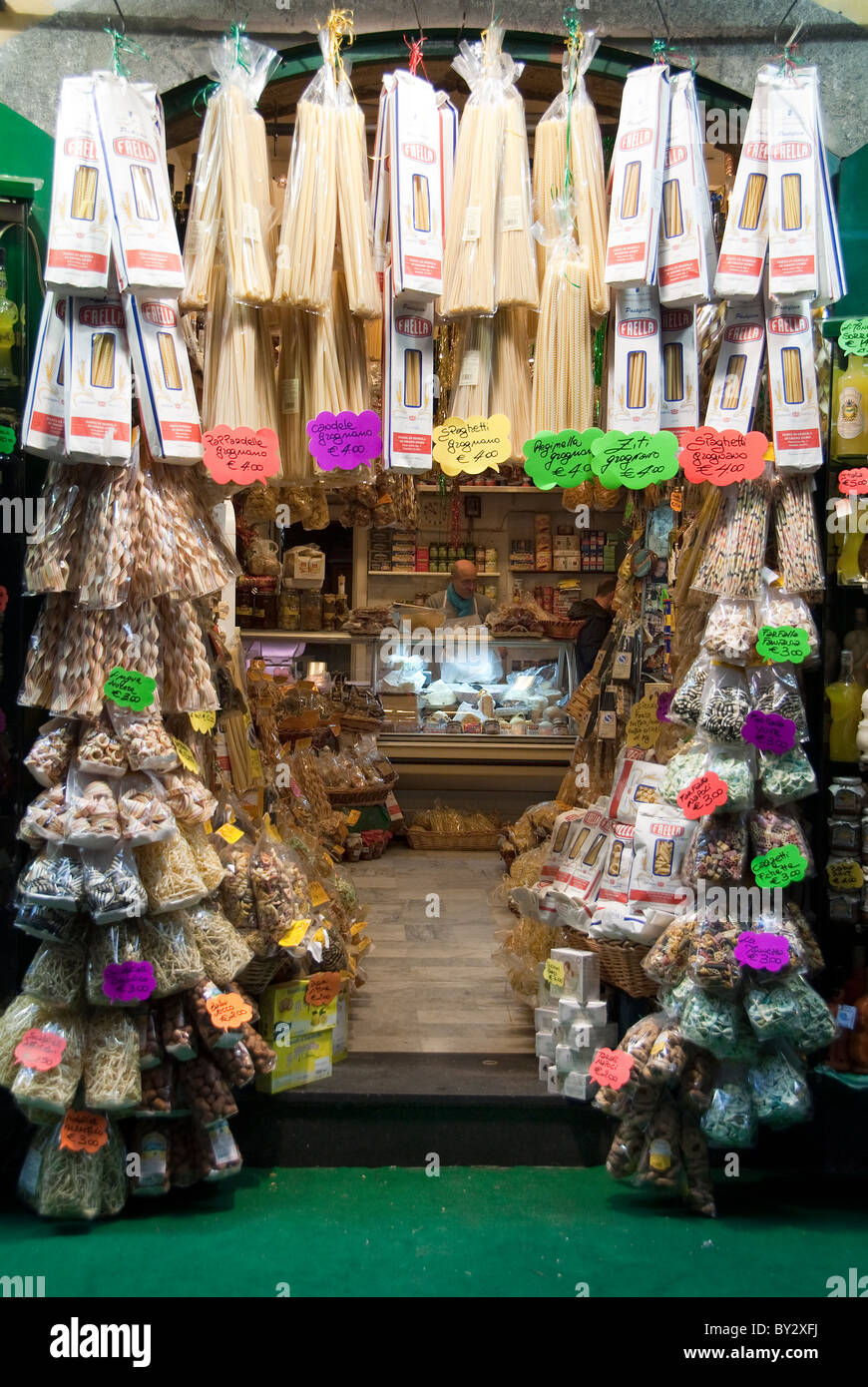 Alimentari or food shop specializing in Pasta in the Spaccanapoli street of Naples, Italy.  The shopkeeper is visible. Stock Photo