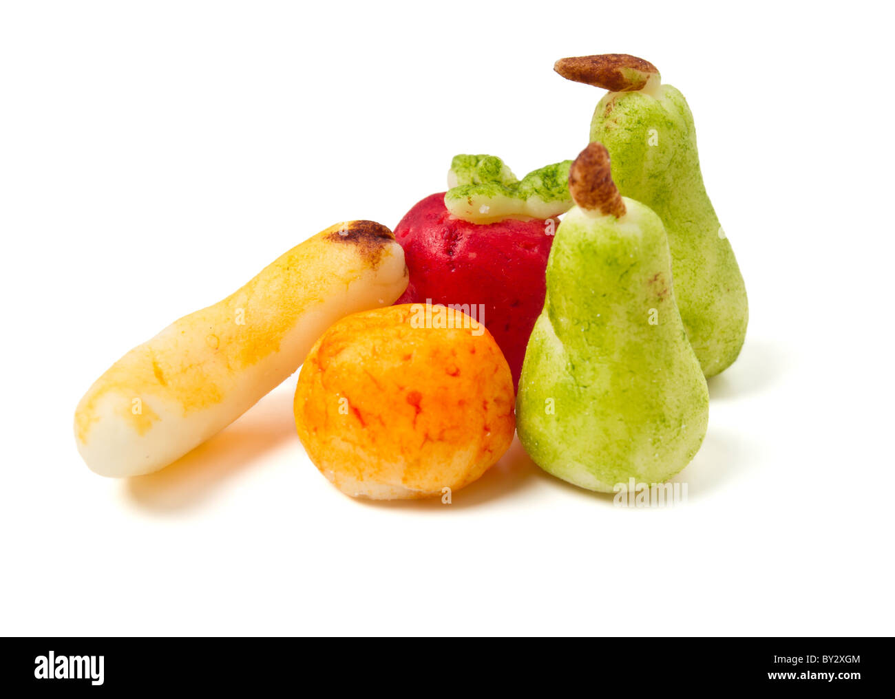 Homemade Marzipan Fruit cake decorations of banana, apple, orange and pear isolated on white. Stock Photo