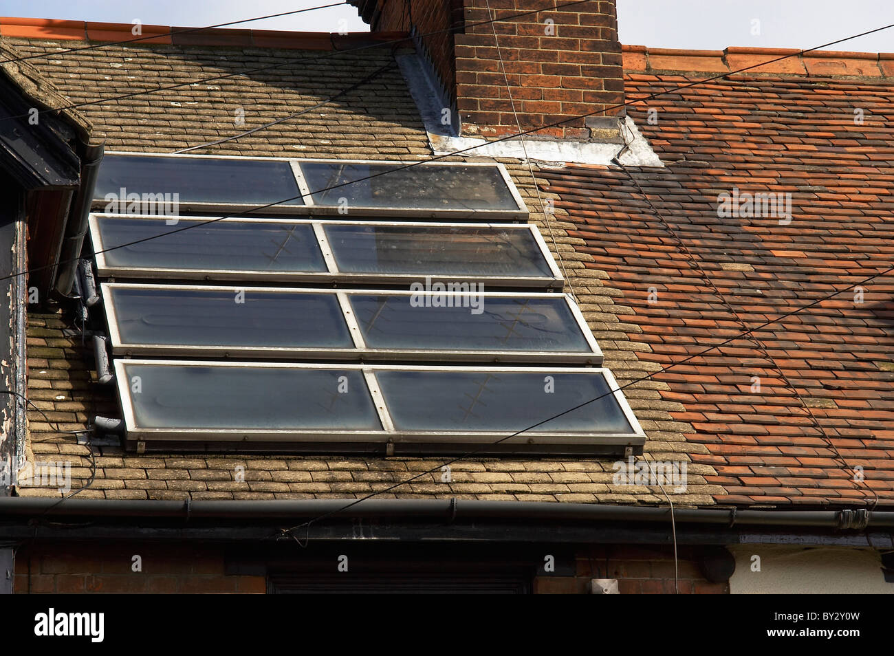 Residential property with solar panels in the roof. Stock Photo