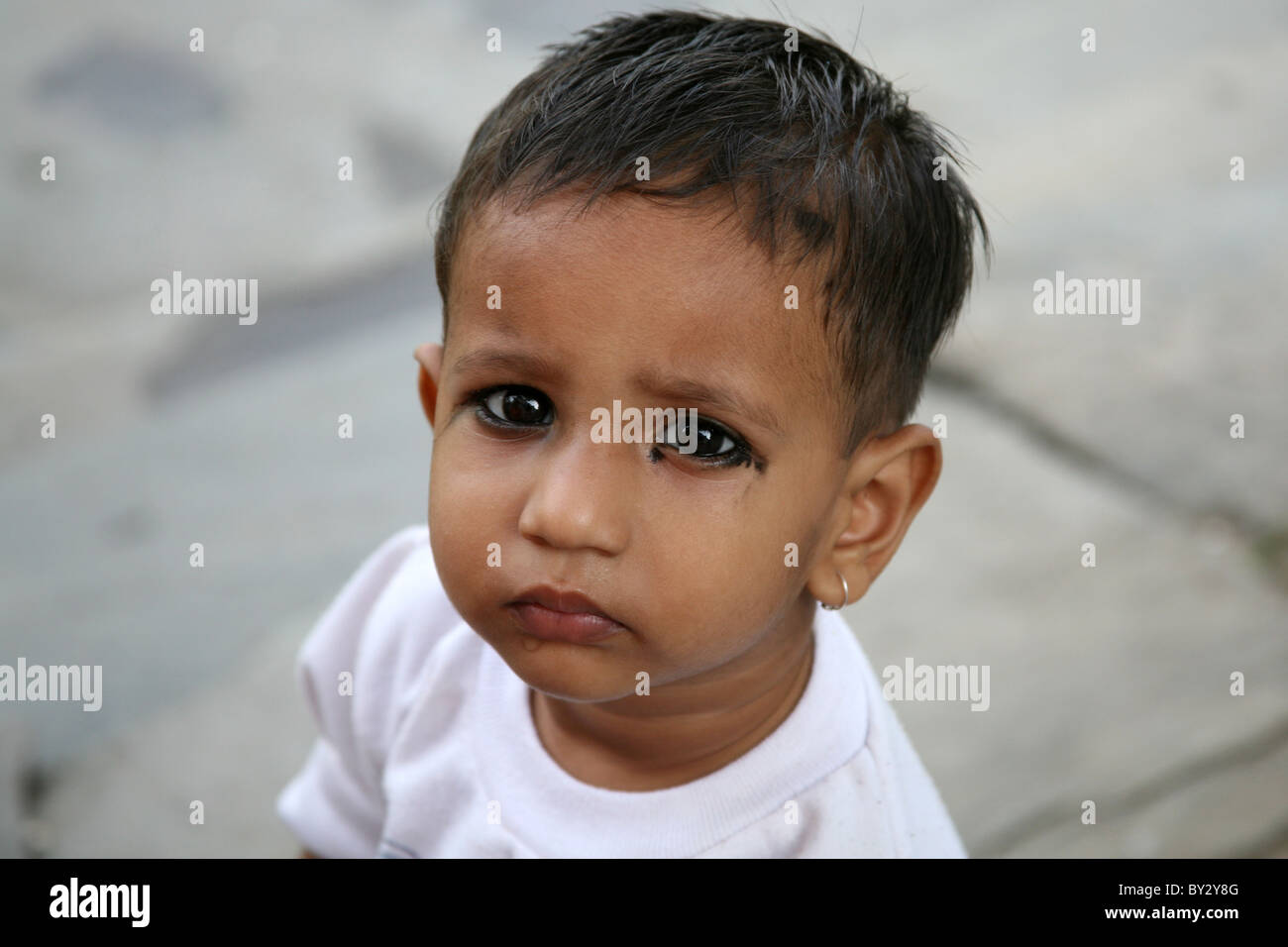 Portrait of an Indian child with kohl around their eyes Stock Photo