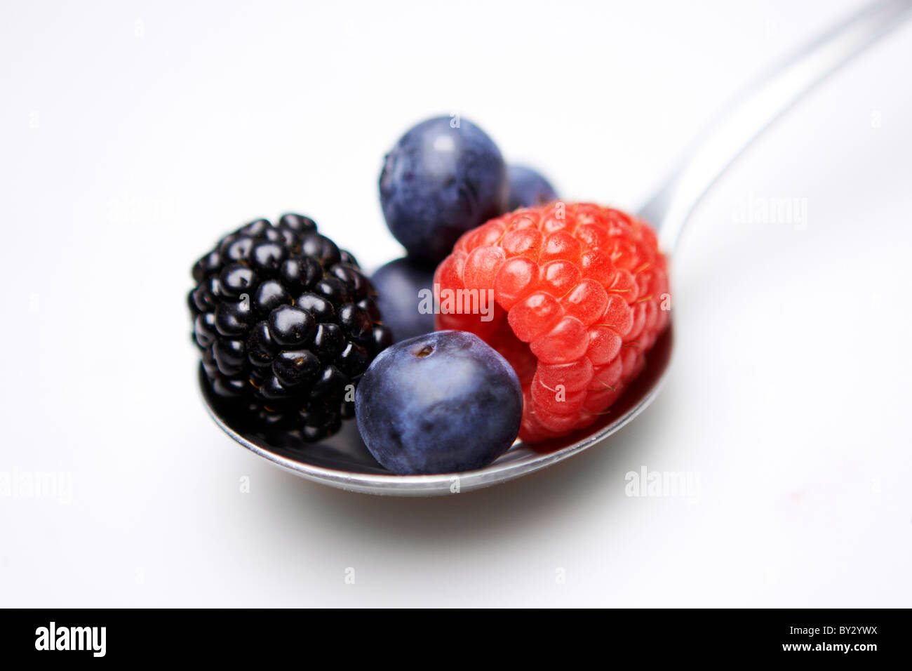 Spoonful of assorted berries closeup concept - five a day Stock Photo