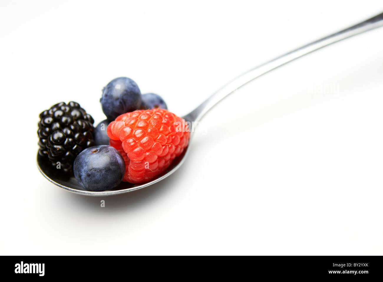 Spoonful of assorted berries closeup concept - five a day Stock Photo